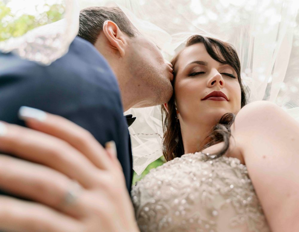 An intimate wedding portrait captured in soft natural lighting.