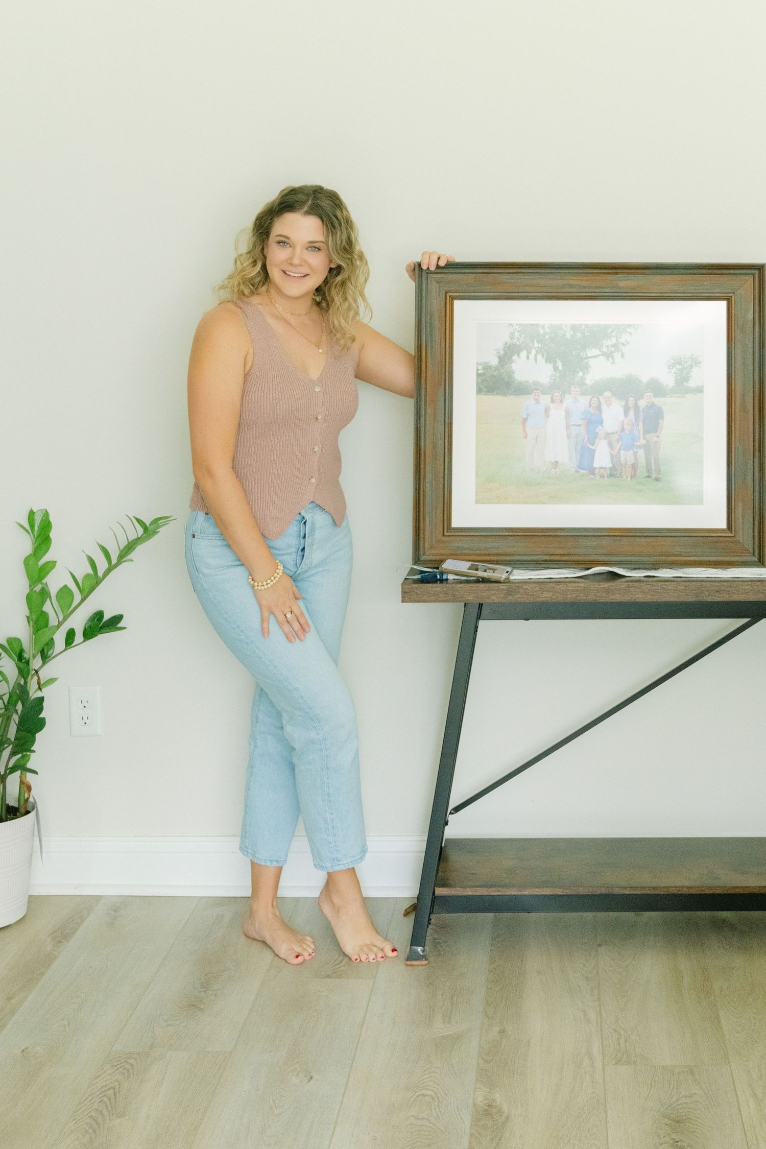 St. Simons Island family photographer displaying a custom framed portrait from the Templeton family's Frederica session.