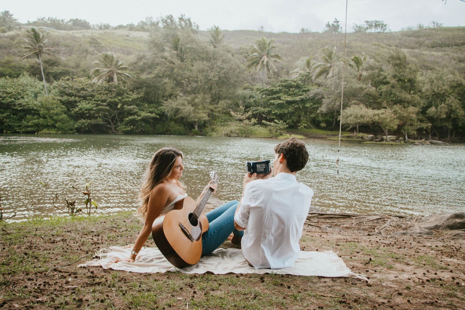 Couple taking a moment during romantic Engagment session by the lush green mountains and breathtaking scenery of Kauai.