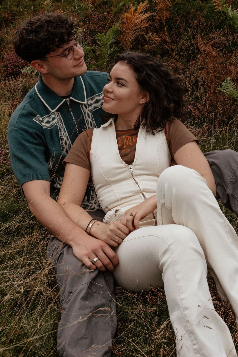 Intimate couple portrait session in autumn grass at sunset.