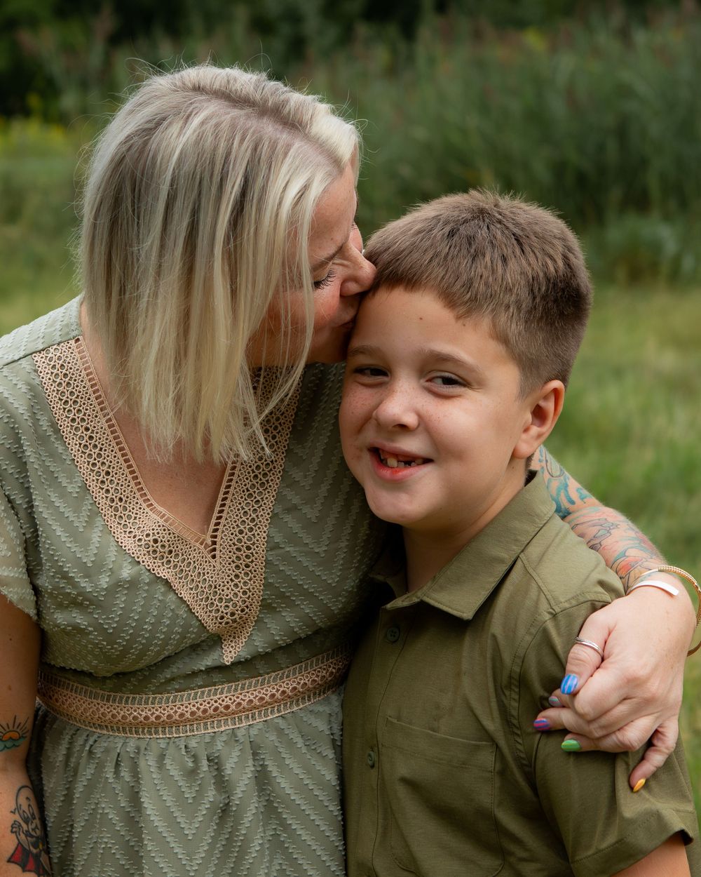 Mom kisses son on forehead in strongsville.