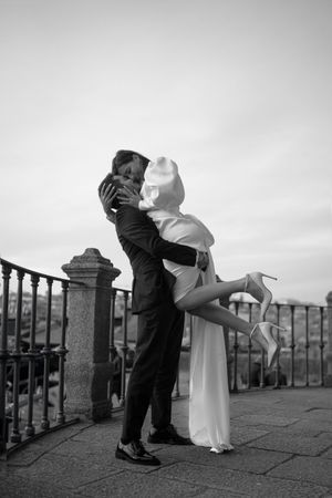Black and white sequence of a romantic dance dip pose against an iron railing.