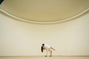 Minimalist architectural scene with curved white walls and clean lines.
