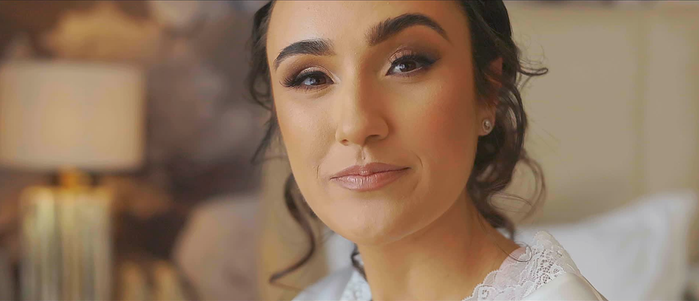 Bride having her hair and makeup completed before the wedding ceremony.