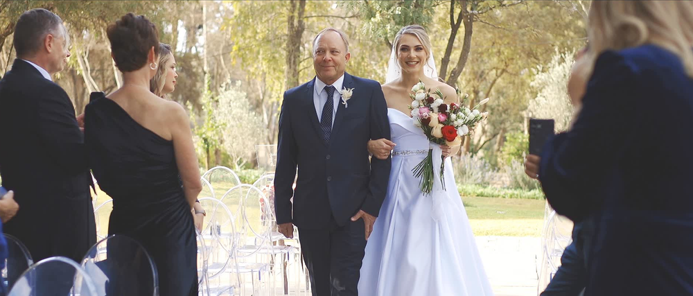 Bride walking down the aisle during her South African wedding ceremony.