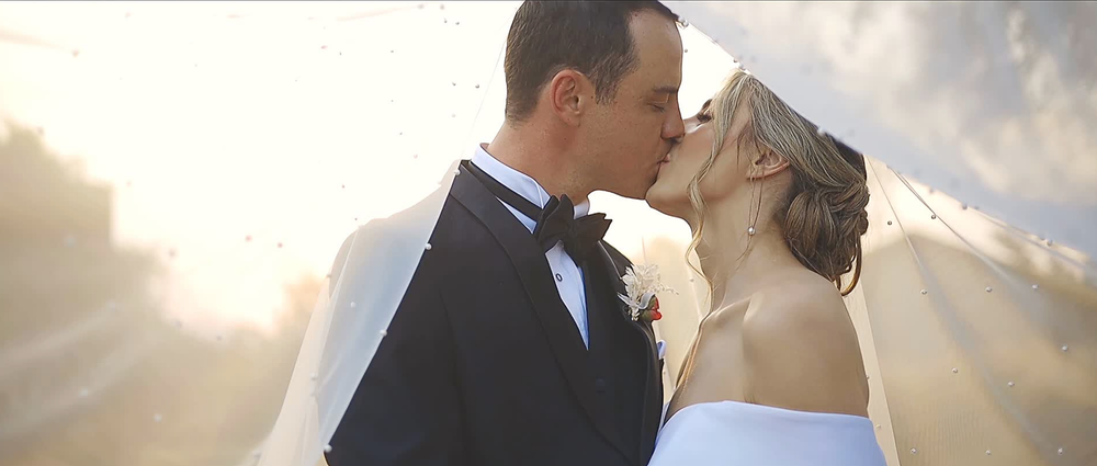 Bride and groom sharing a kiss during their wedding couple session.