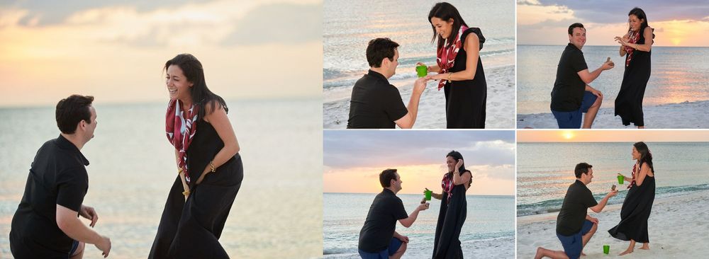 Joyful beach marriage proposal at sunset with man on knee and woman in black dress.