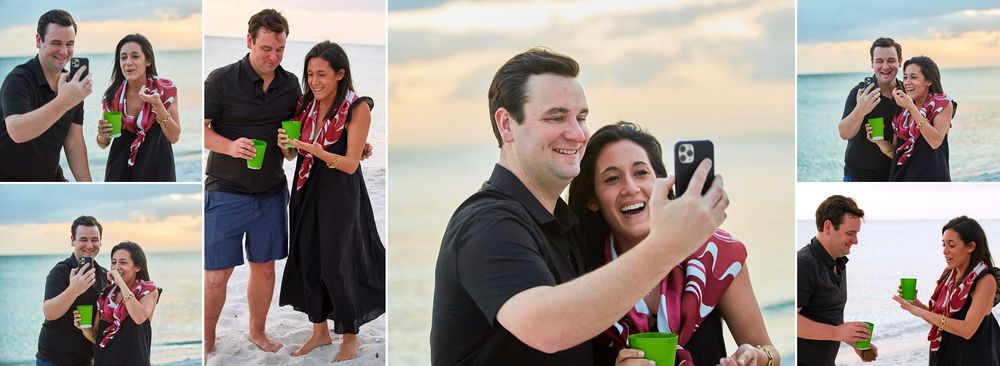 Happy couple celebrating beach engagement taking selfie with green drinks at sunset.