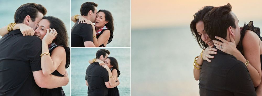 Joyful couple embracing on beach at sunset after romantic marriage proposal.