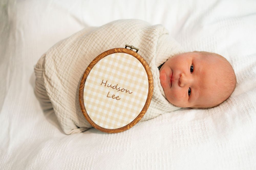 Newborn baby swaddled in cream fabric during a Fresh 48 session at Parkwest Medical Center in Knoxville, TN.