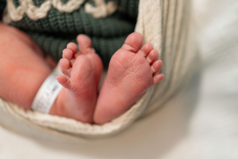 Close-up of newborn baby feet with hospital ID bracelet during a Fresh 48 session at Parkwest Medical Center in Knoxville, TN.