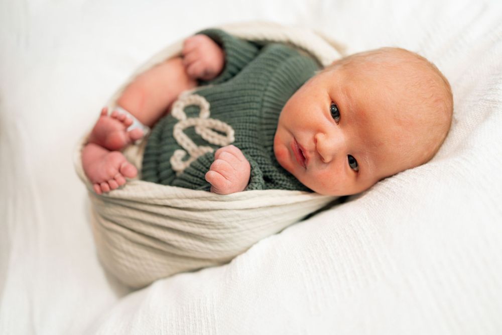 Newborn baby wrapped in cream knit blanket during a Fresh 48 session at Parkwest Medical Center in Knoxville, TN.
