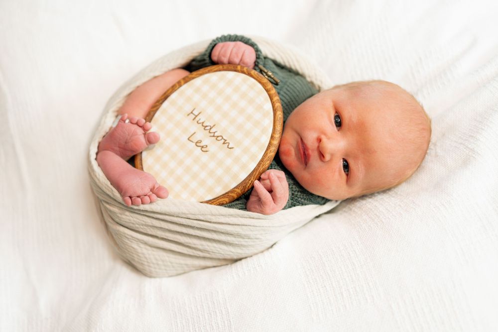 Newborn baby swaddled in cream wrap during a Fresh 48 session at Parkwest Medical Center in Knoxville, TN.