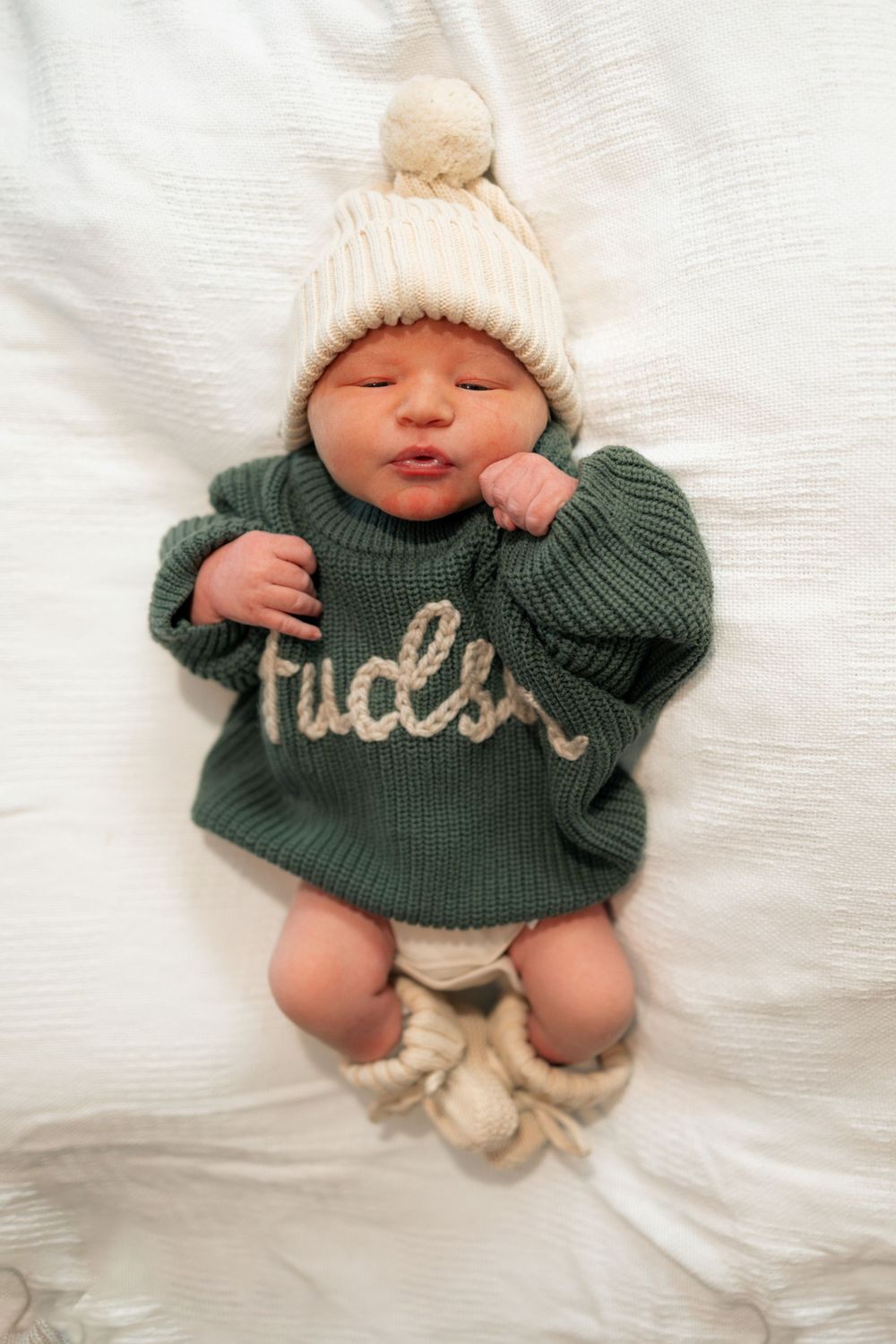 Newborn baby named Hudson wearing a green knit sweater during a Fresh 48 session at Parkwest Medical Center in Knoxville, TN.
