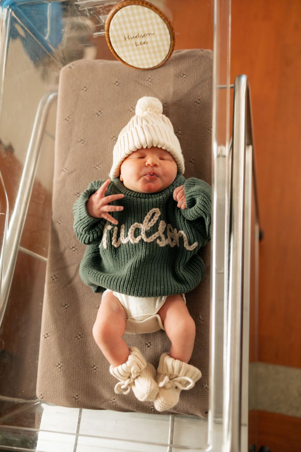 Newborn baby named Hudson in green knit sweater during a Fresh 48 session at Parkwest Medical Center in Knoxville, TN.