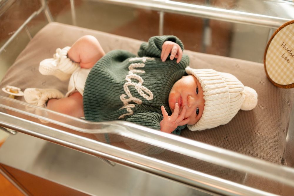 Newborn baby in green knit outfit during a Fresh 48 session at Parkwest Medical Center in Knoxville, TN.