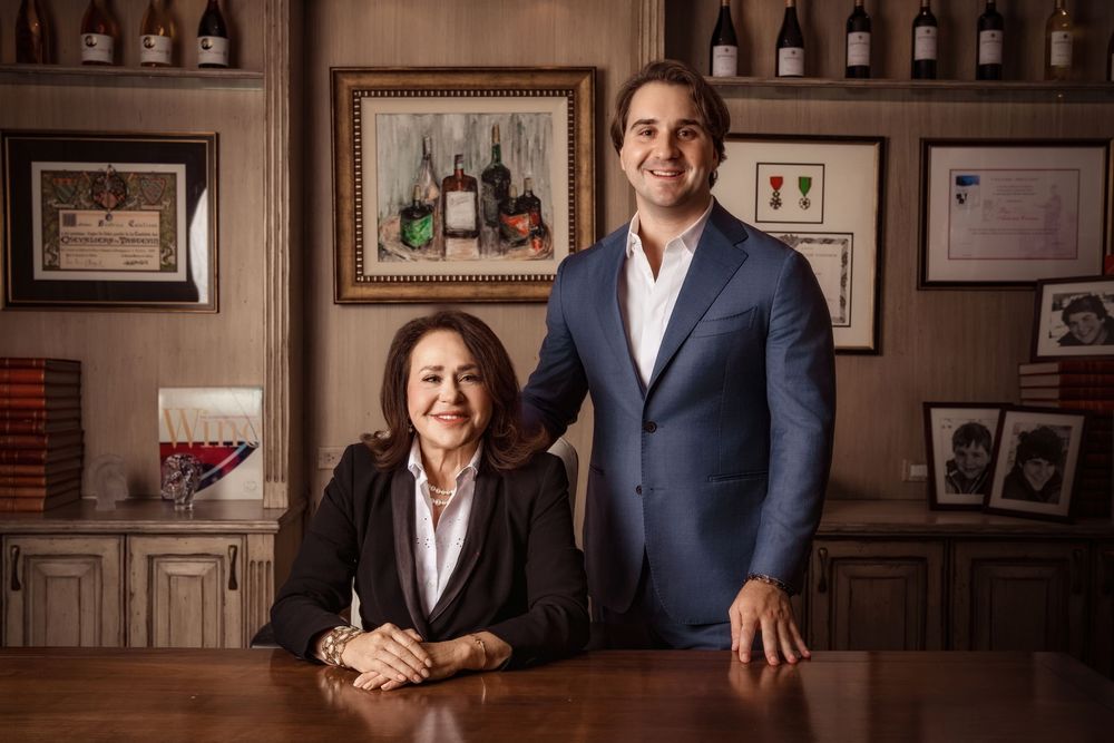 Miami personal branding portrait of two business professionals in blue and black suits inside a wine office.