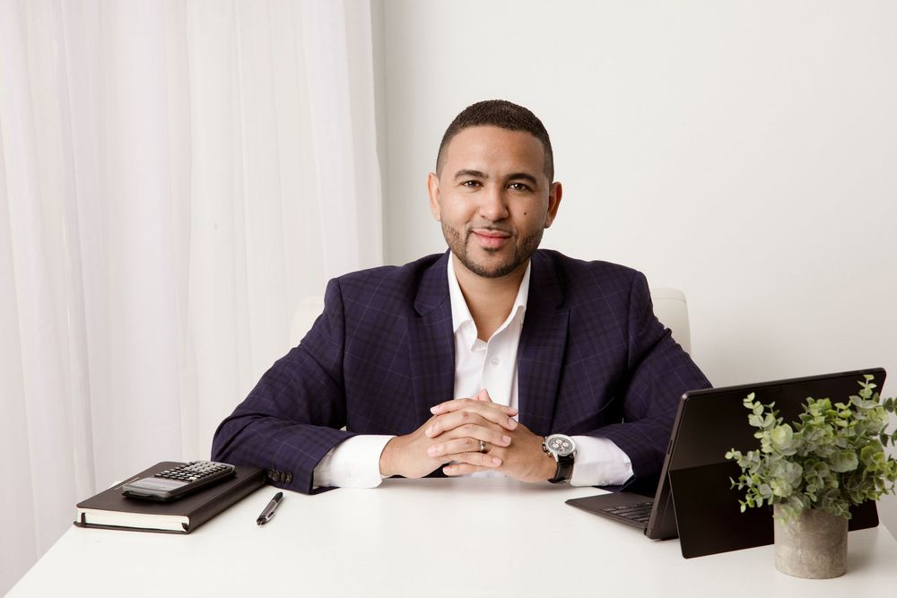 Miami personal branding portrait of a business professional seated at a desk with a laptop and notebook.