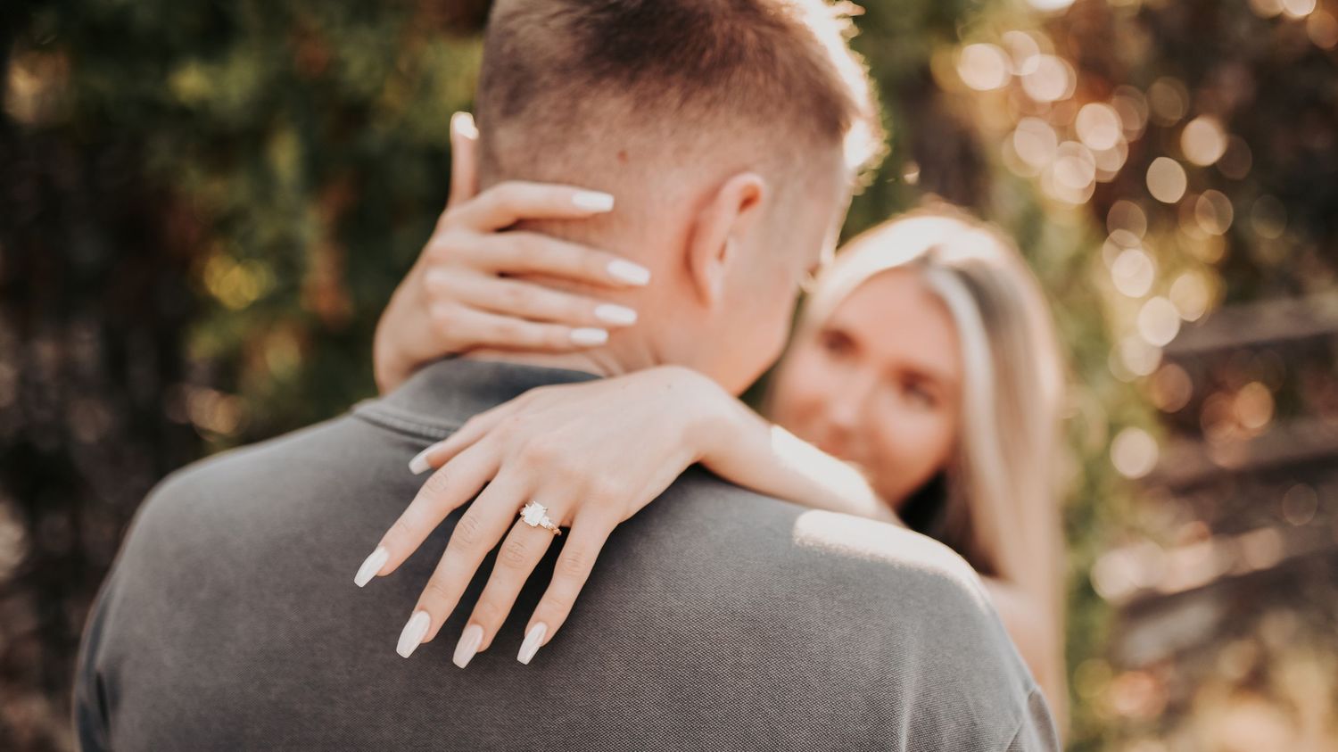 Bride-to-be receiving her engagement ring during a surprise proposal