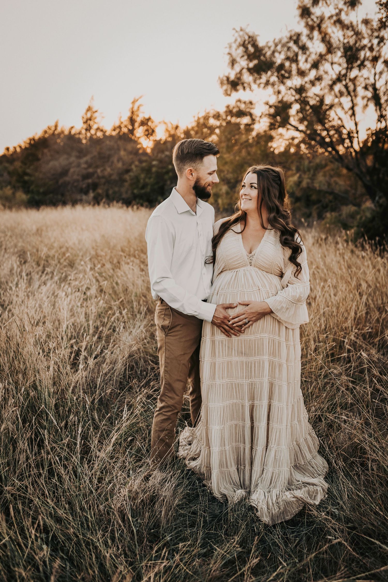 Expecting mom surrounded by her husband and sons during a sunset maternity session
