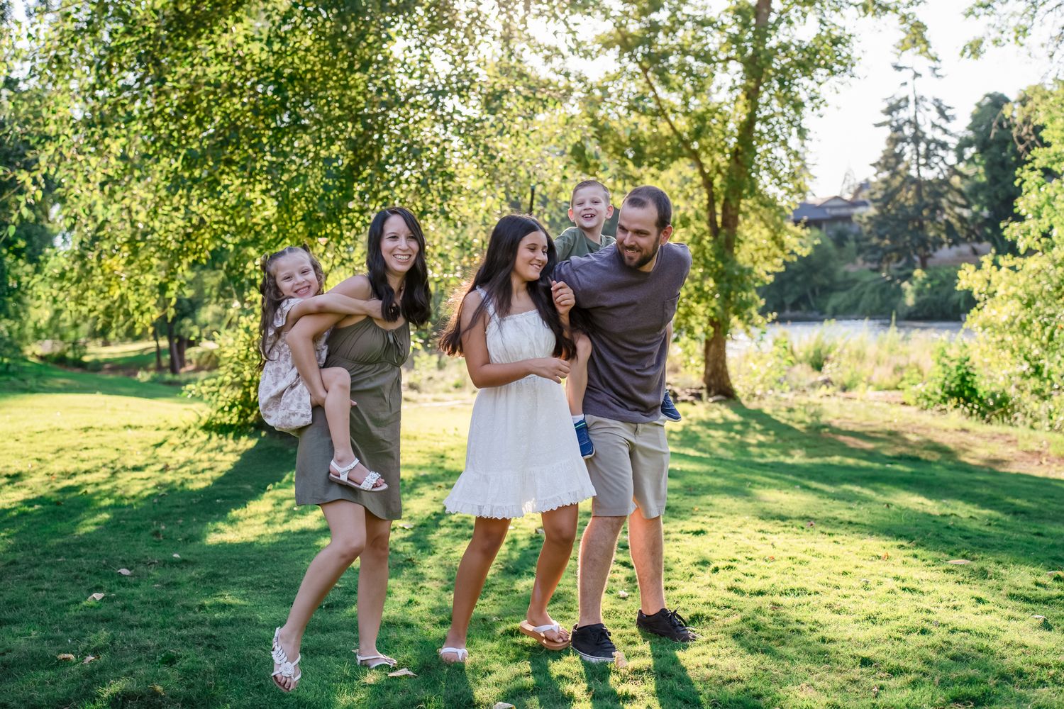 Family of 5 plays together for a family portrait on grass