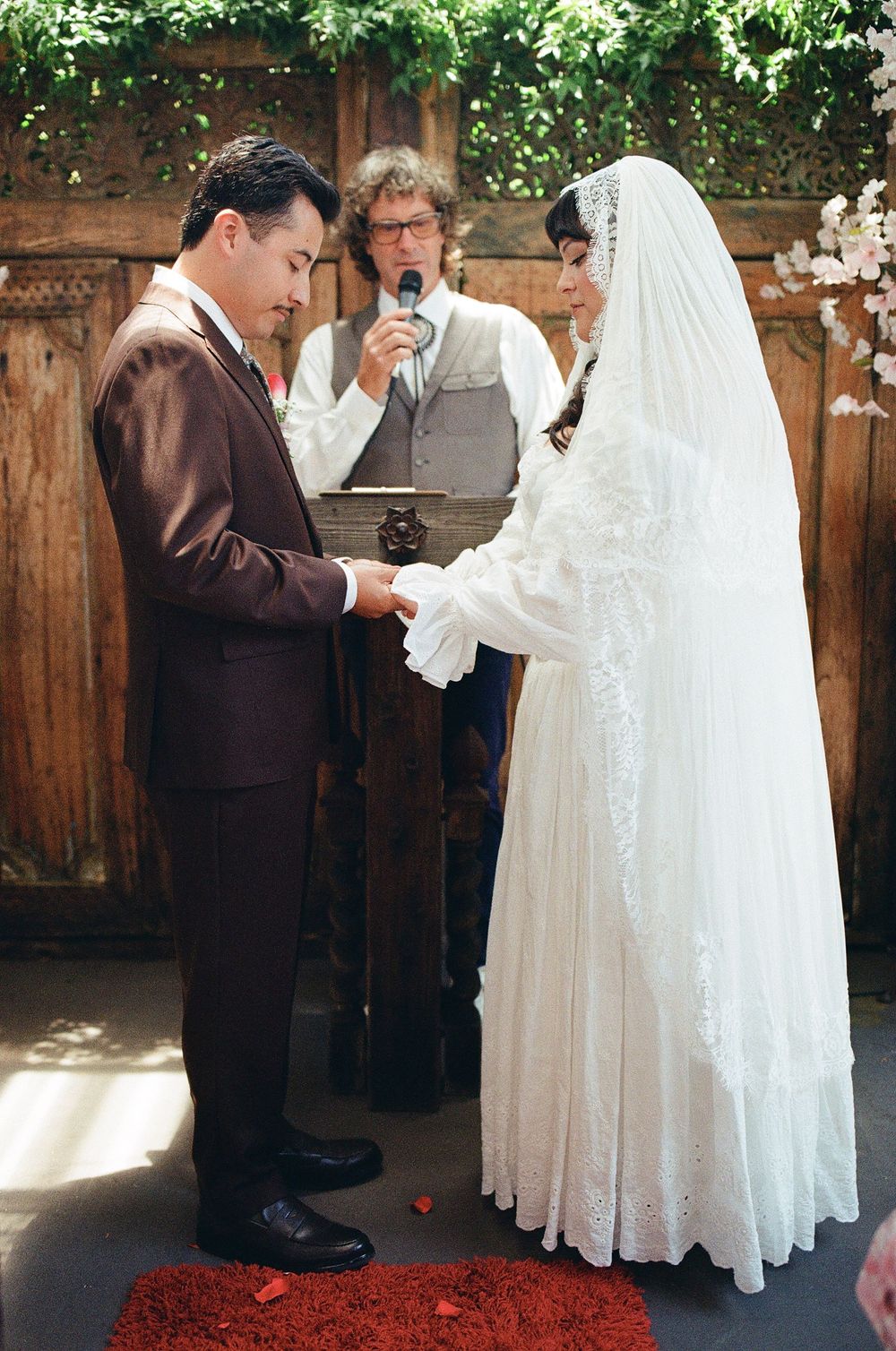 bride and groom exchanging rings, film wedding photography