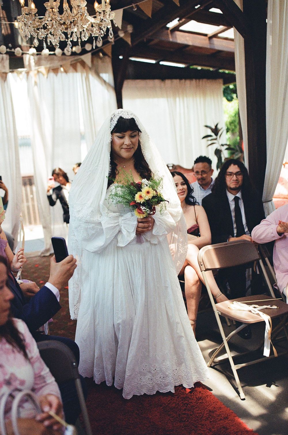 bride walking herself down the aisle to meet her partner at los angeles wedding, film wedding photography