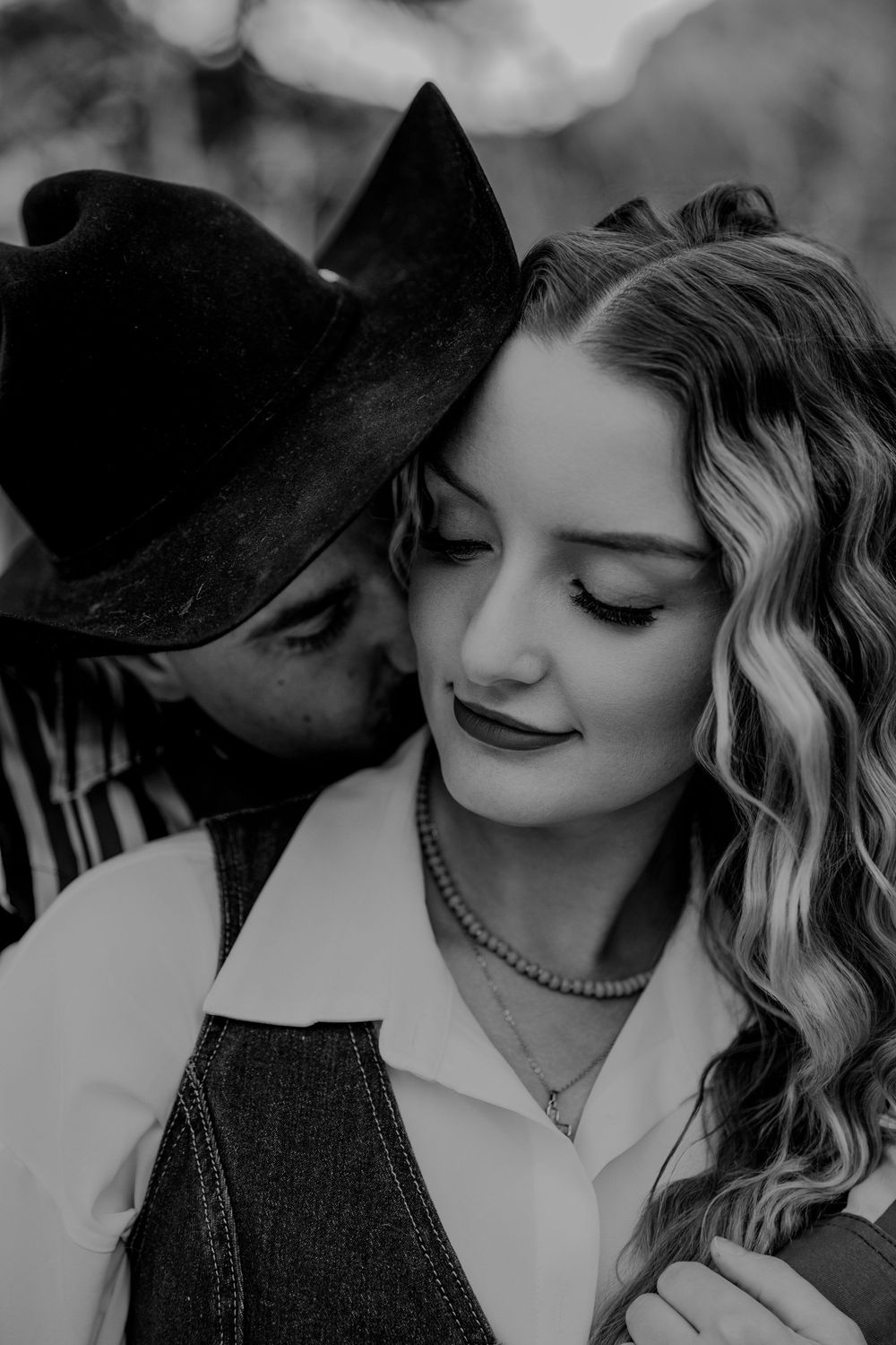 Black and white romantic photo series showing intimate moments between a couple in vintage-inspired styling.