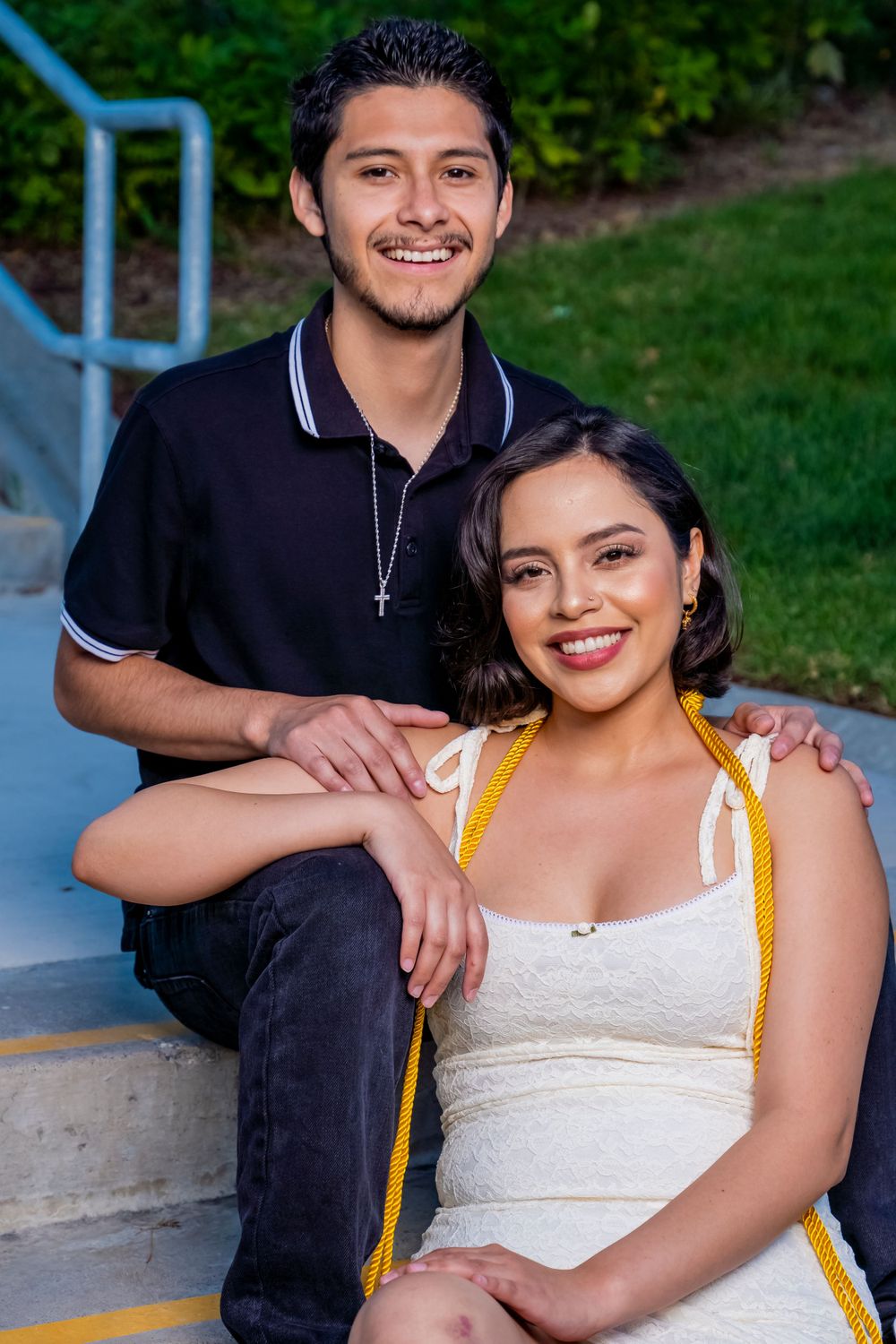 A joyful moment captured on outdoor steps during a graduation celebration.