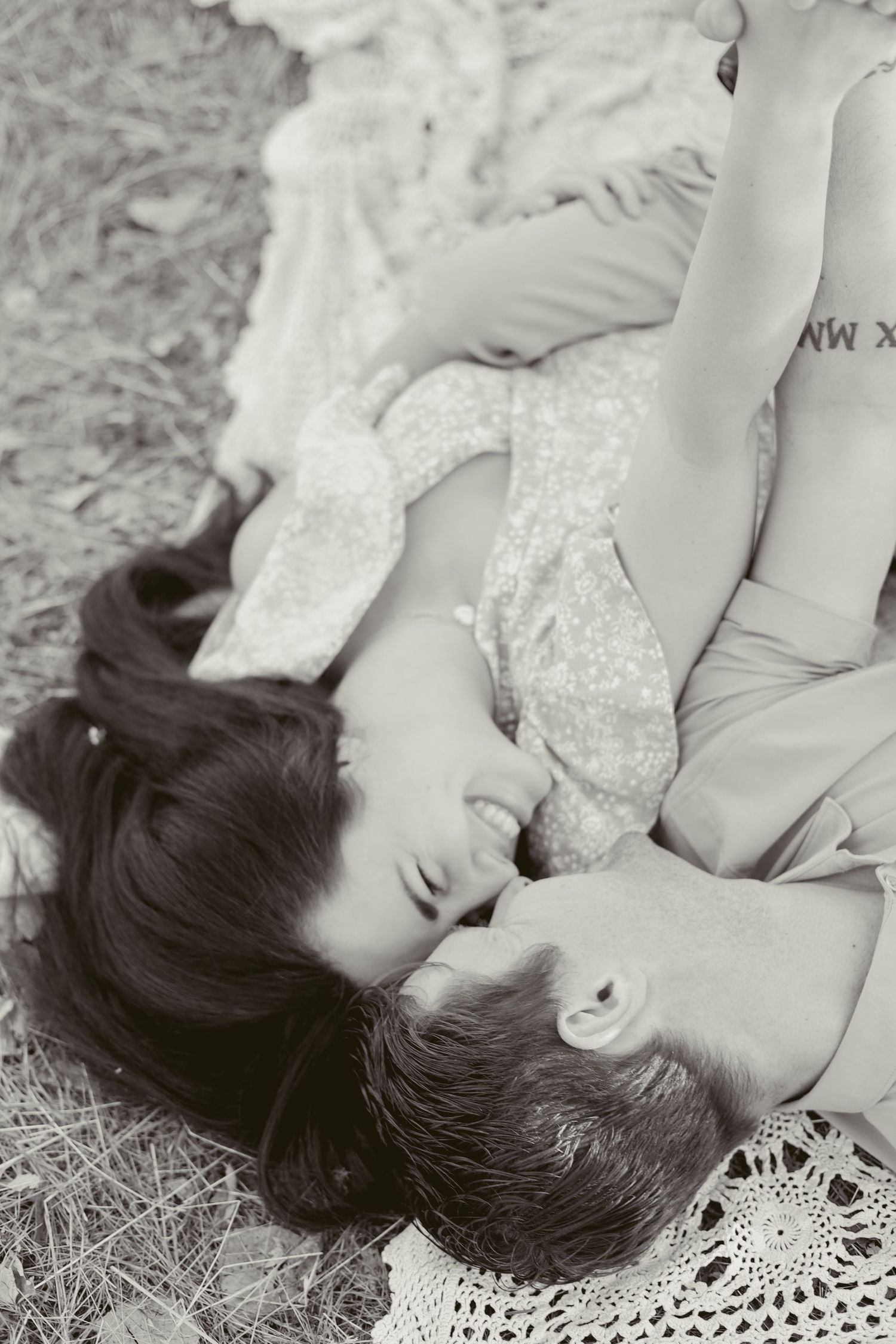 A romantic black and white portrait on lace featuring intimate poses.