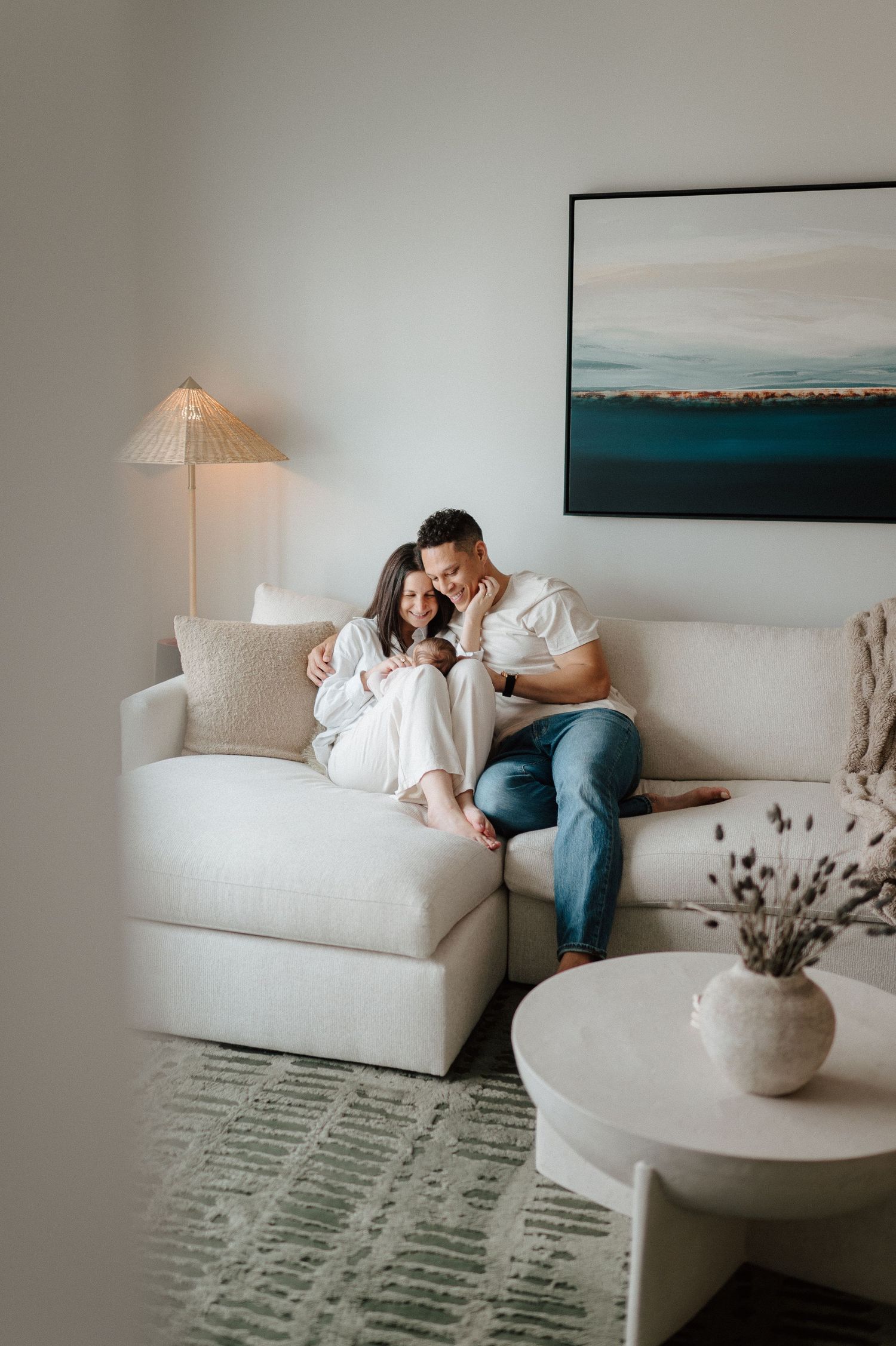 Casual lifestyle photos of couple relaxing together on white couch at home.