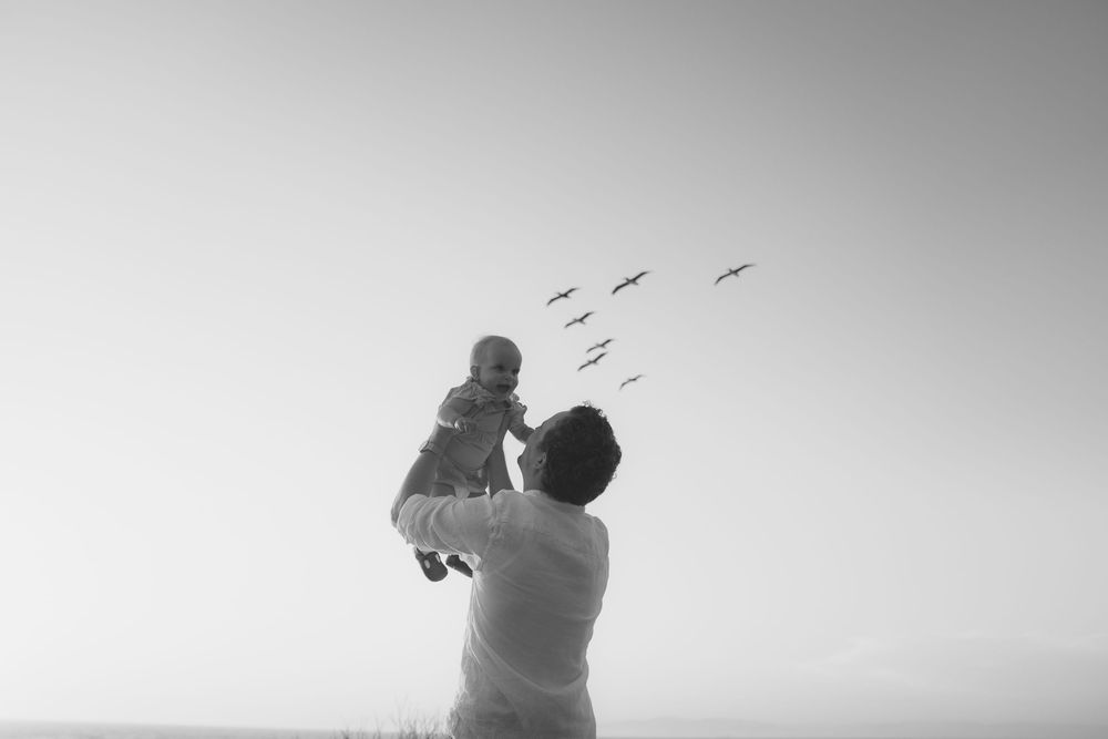 dad lighting up daughter to see birds during photo shoot by SoCal photographer