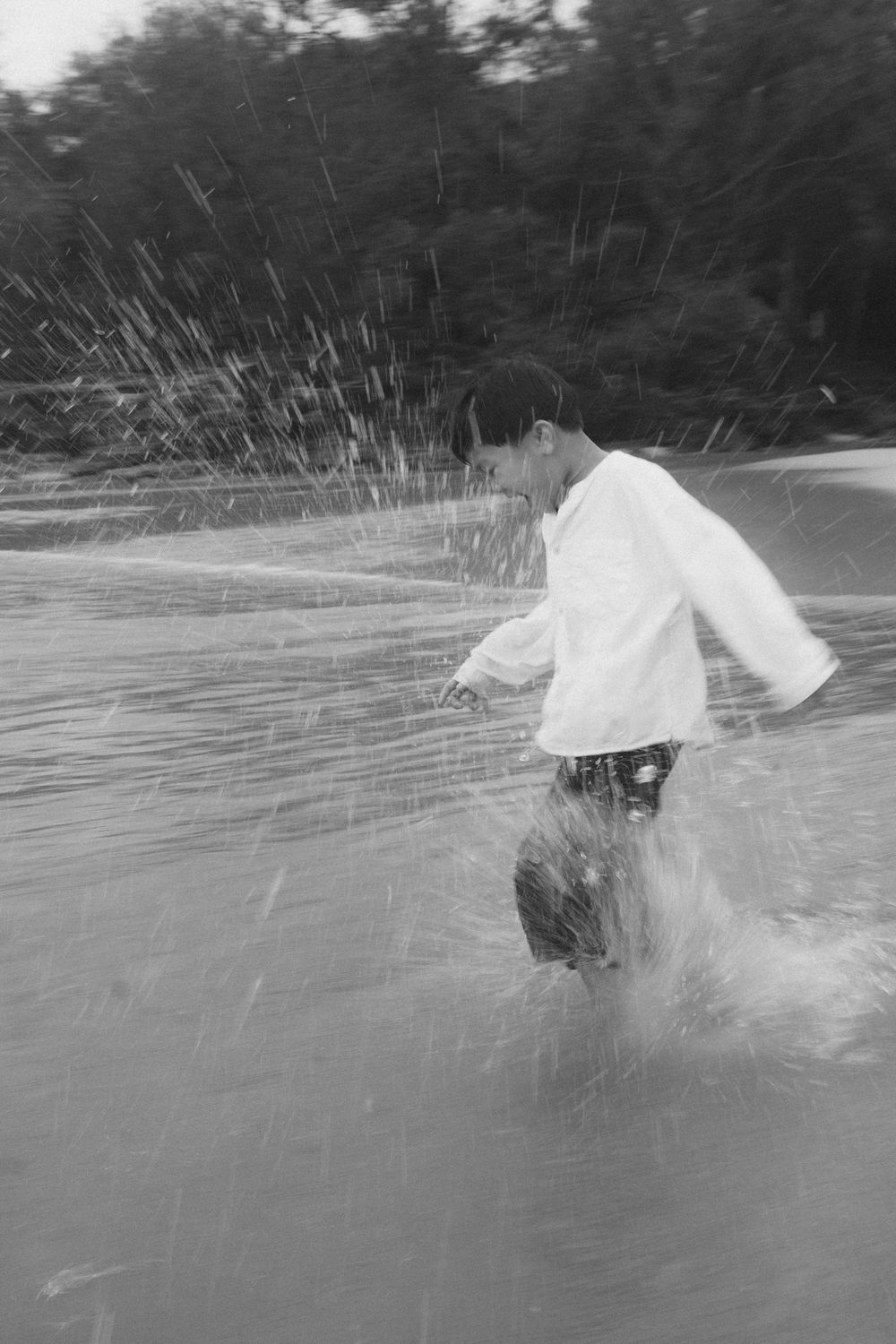 kid running in the ocean during kauai photo shoot by kauai photographer