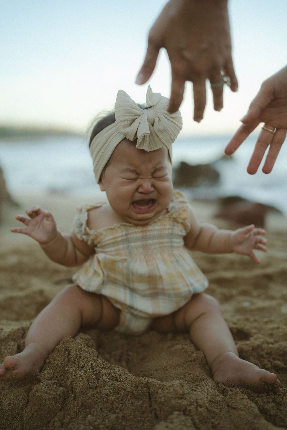 baby crying during photo shoot in Poipu by Kauai photographer