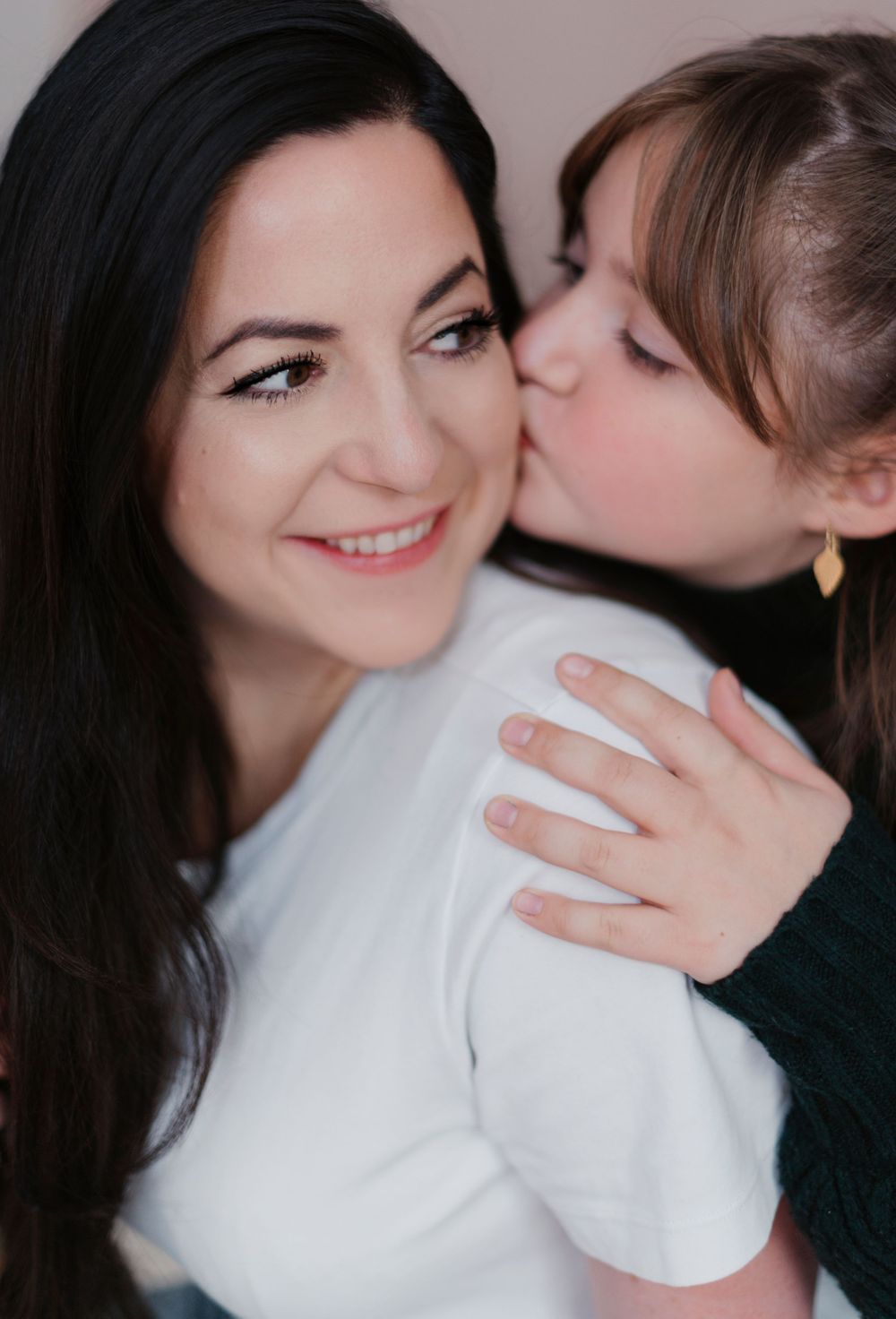 A tender moment captured in a series of black and white intimate photographs showing affection between two people.