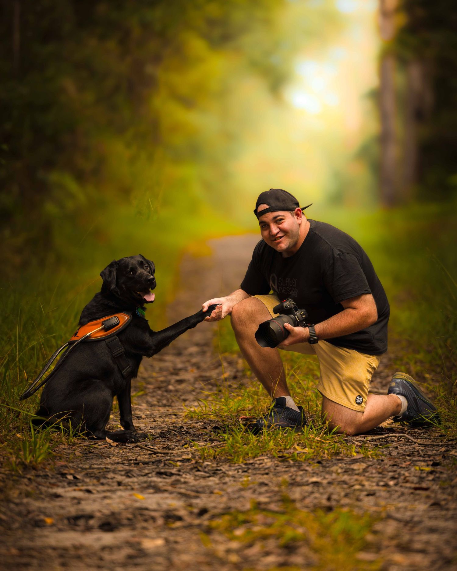 Legally blind photographer sitting with his guide dog and holding a camera, Sunshine Coast Queensland, Australia. That blind guy.