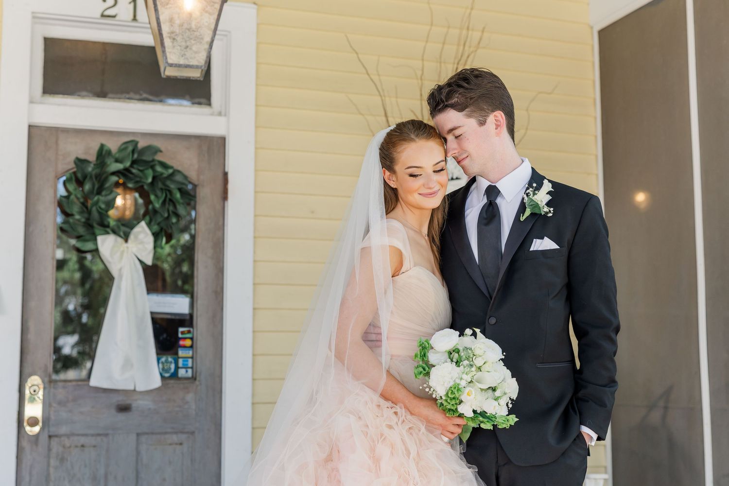 Elegant bride and groom share intimate moments in a dreamy outdoor wedding photoshoot.
