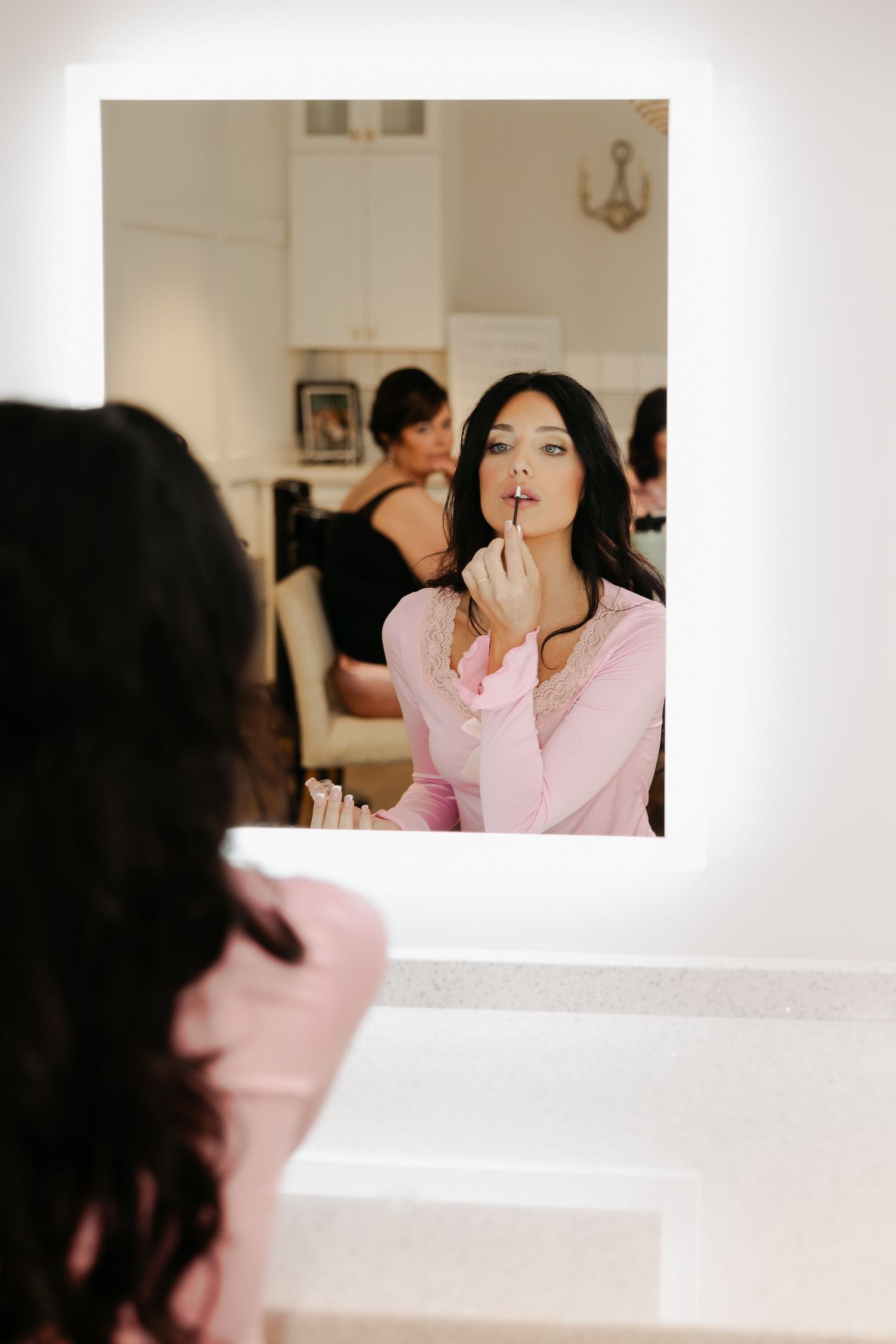 Bride ditches the traditional bridal getting ready outfit and gets ready in a baby pink pajama set.