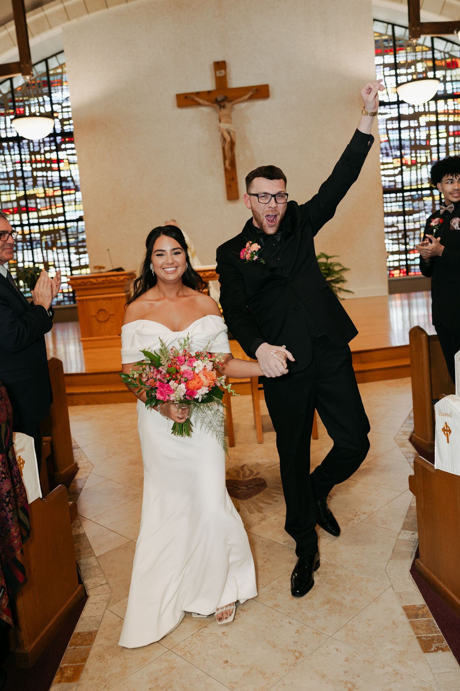Groom cheers after he just kissed his bride after saying 'I do".