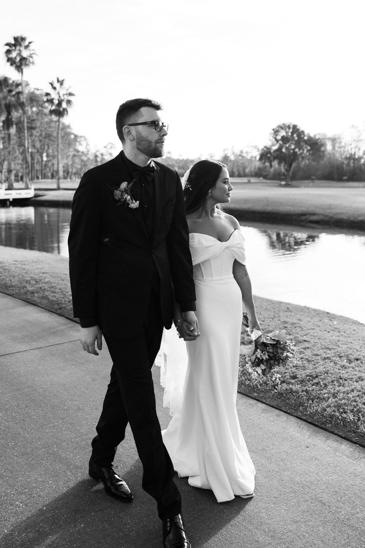 Bride and groom walking along the golf course before they enter their reception.