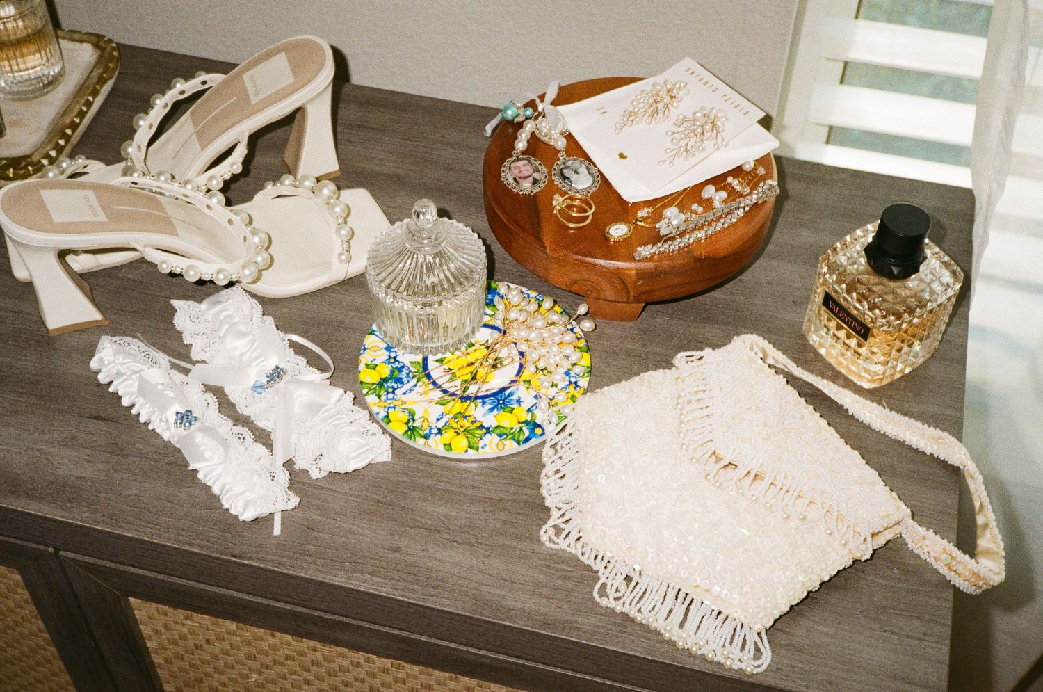 35mm film photo of the brides details. Her shoes, perfume, jewelry, garter, and so many sentimental items.