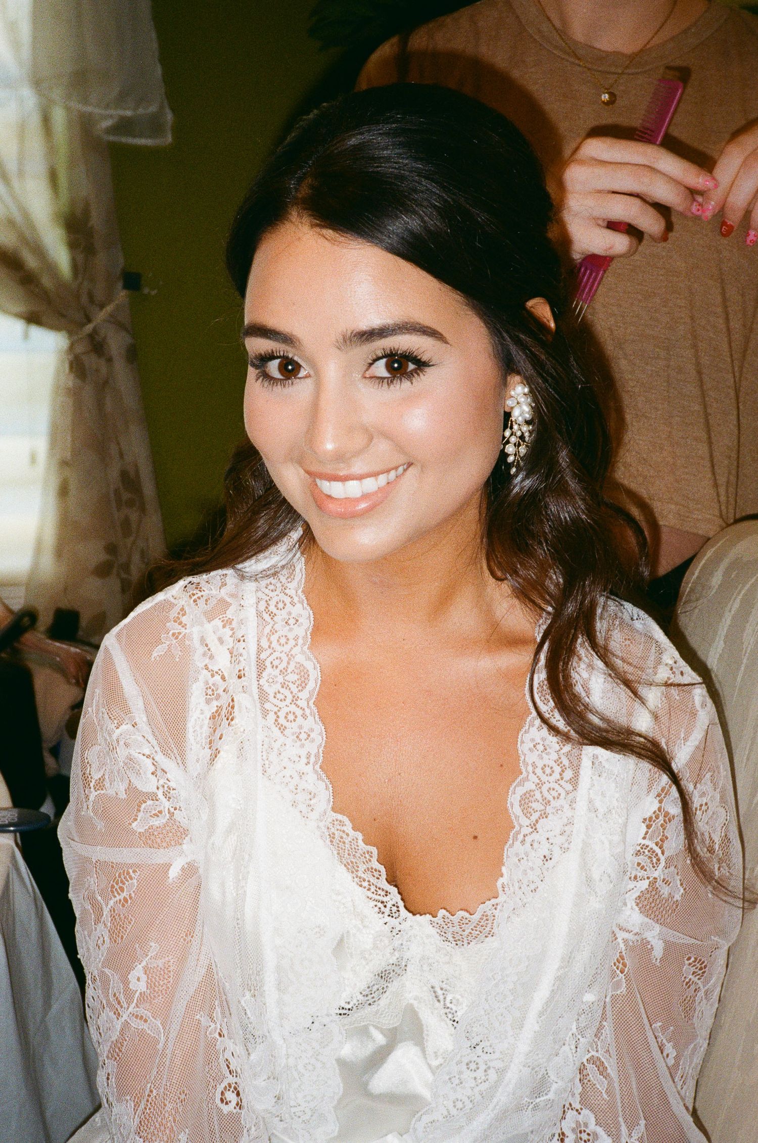 35mm film photo of the beautiful bride getting her hair done on the morning of her wedding day.