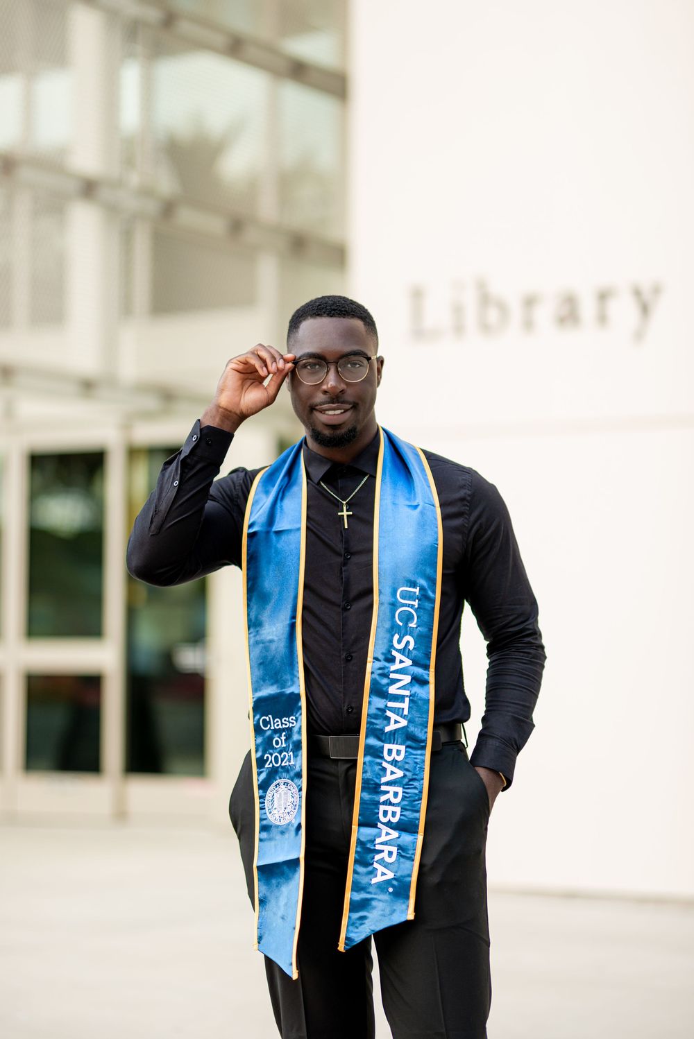 Graduate in black gown and light blue stole celebrates with joyful expressions in three-photo collage.