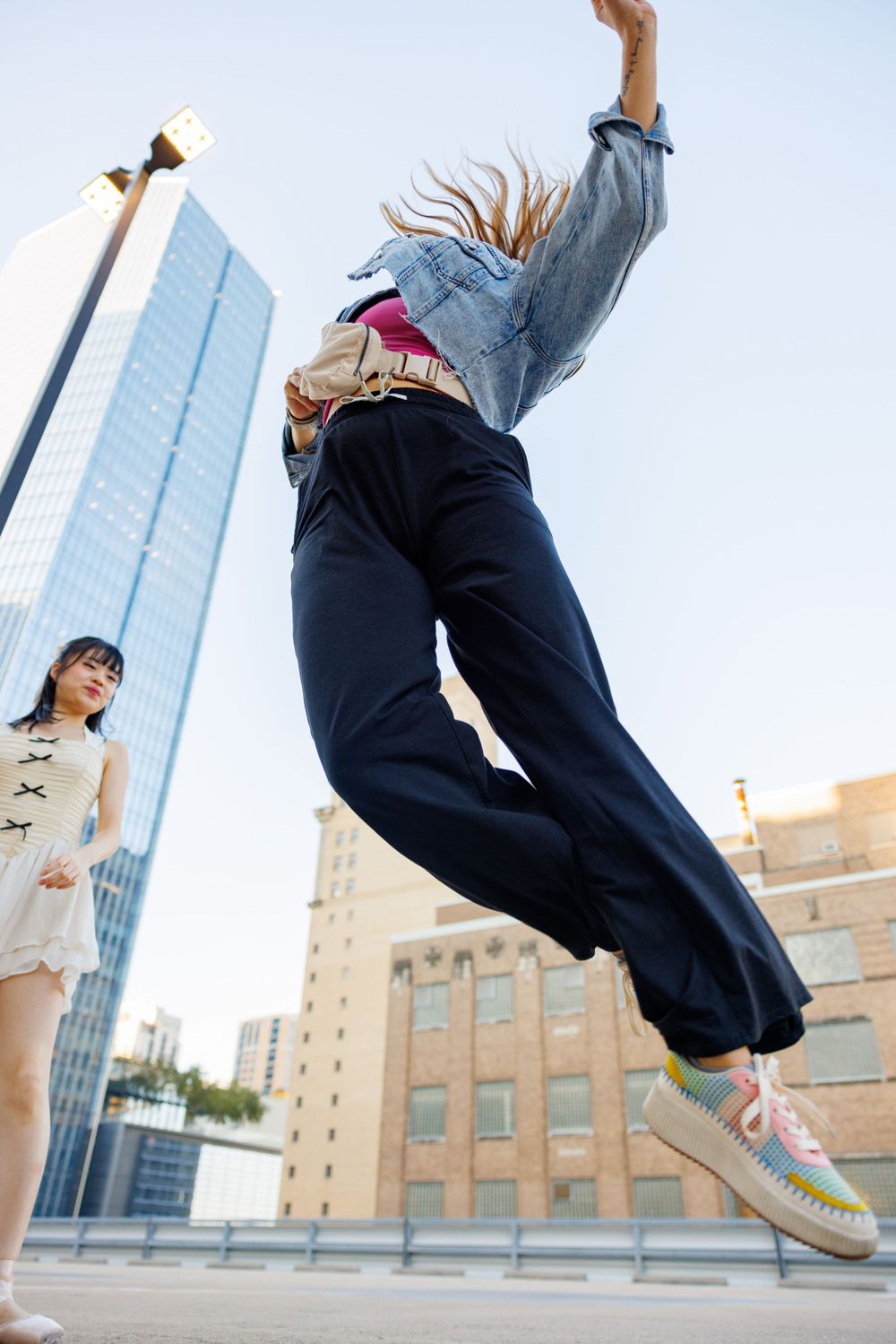 Dynamic shot of dancers practicing choreography against modern city architecture.