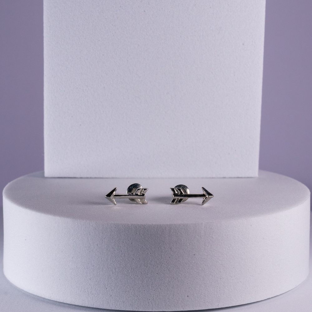 Black arrow-shaped adjustable ring displayed on white circular platform.