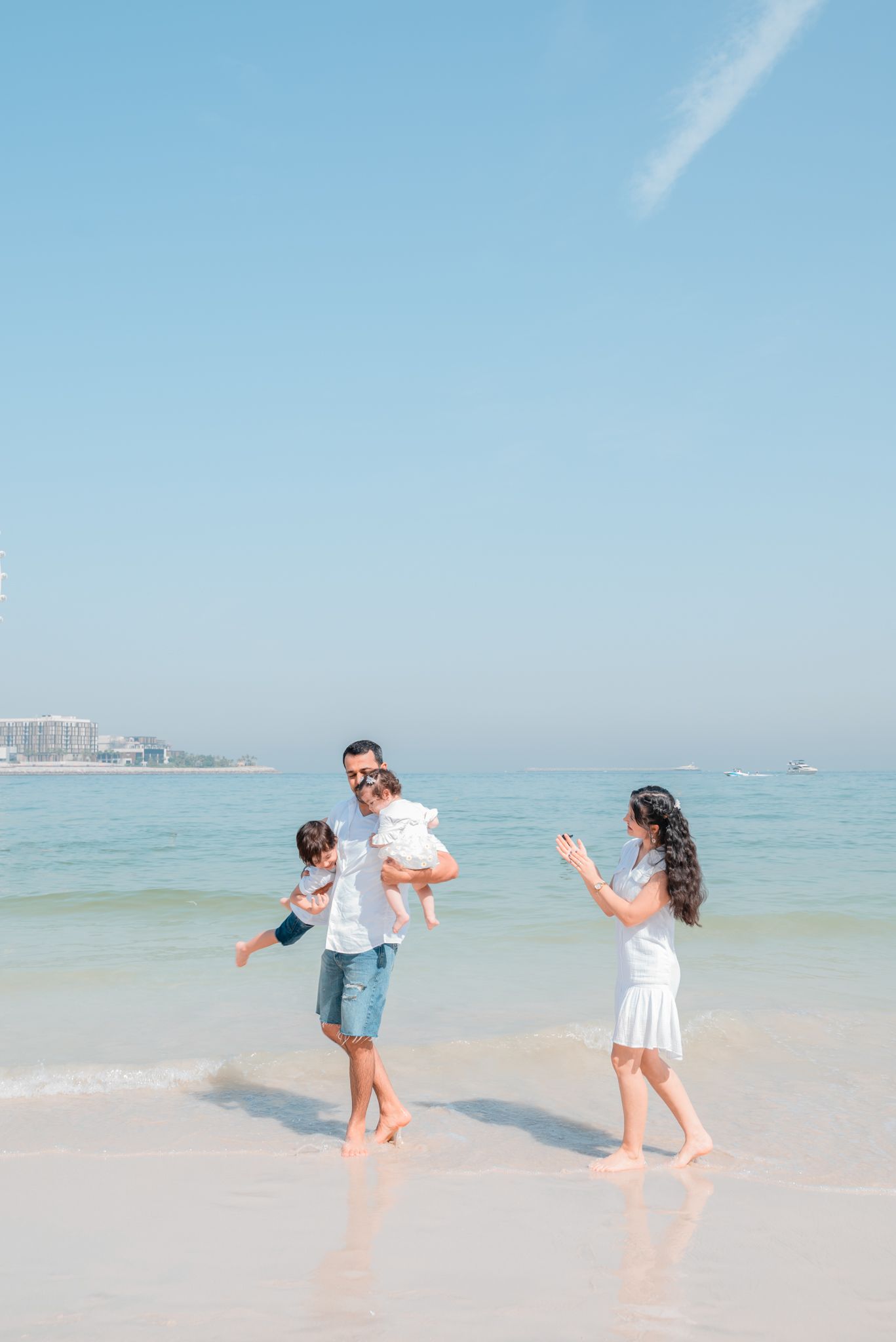 A family enjoys playful moments together, with parents and kids laughing and bonding through fun activities