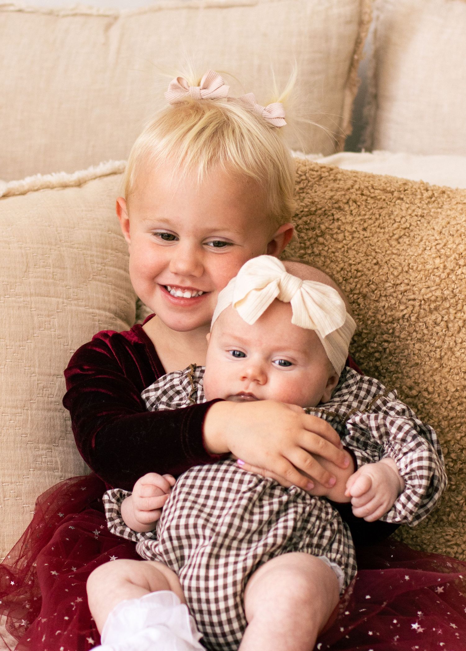 Lifestyle family photography. Toddler holding baby sister. Northern utah photography studio