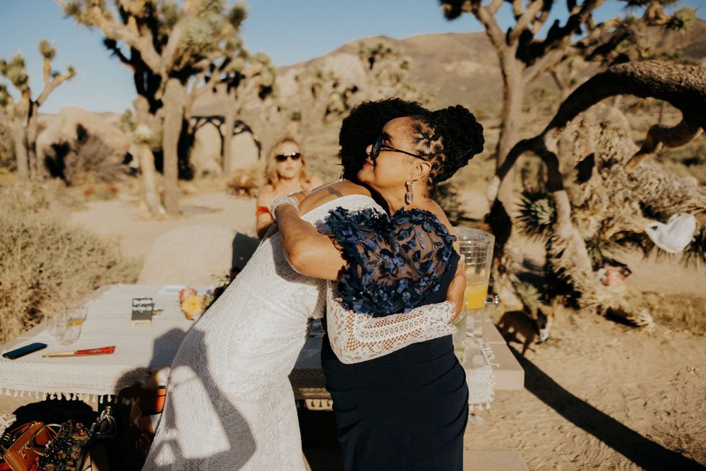 Desert wedding celebration with Joshua trees creating a dramatic natural backdrop.