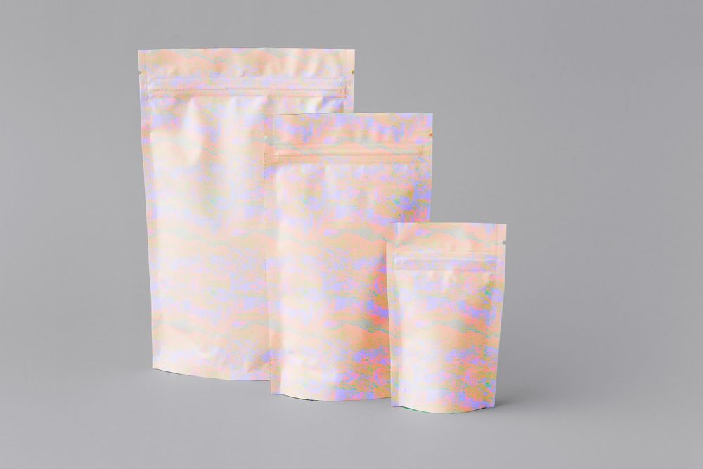 Three pink and white holographic resealable packaging pouches arranged by size.