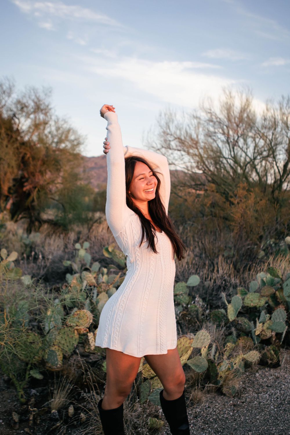 Joyful poses among desert cacti and natural landscape at sunset.